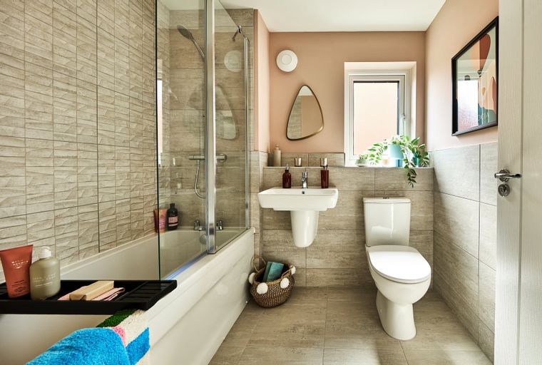 A bathroom with a bathtub, shower, sink, and toilet.