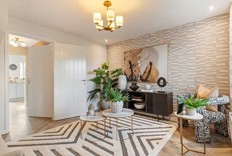 A living room with a patterned chair, console table, and a rug.