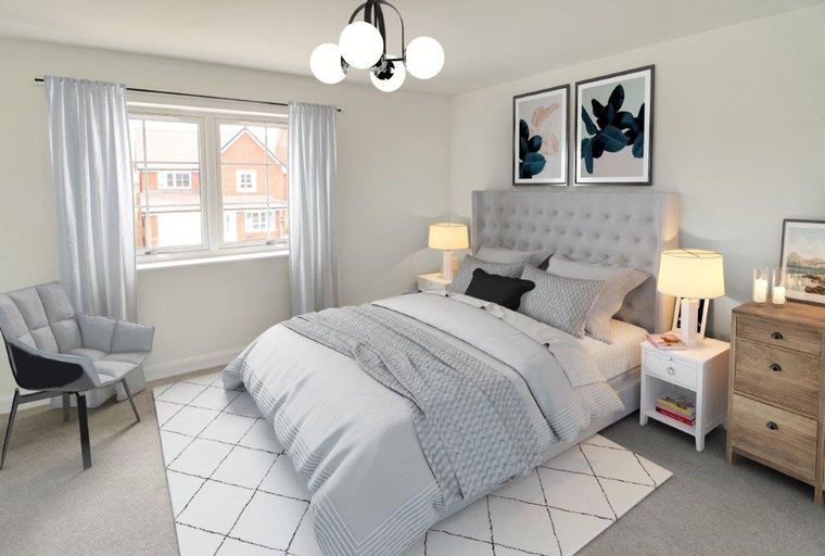 A bedroom with a bed, nightstands, a chair, and a window.