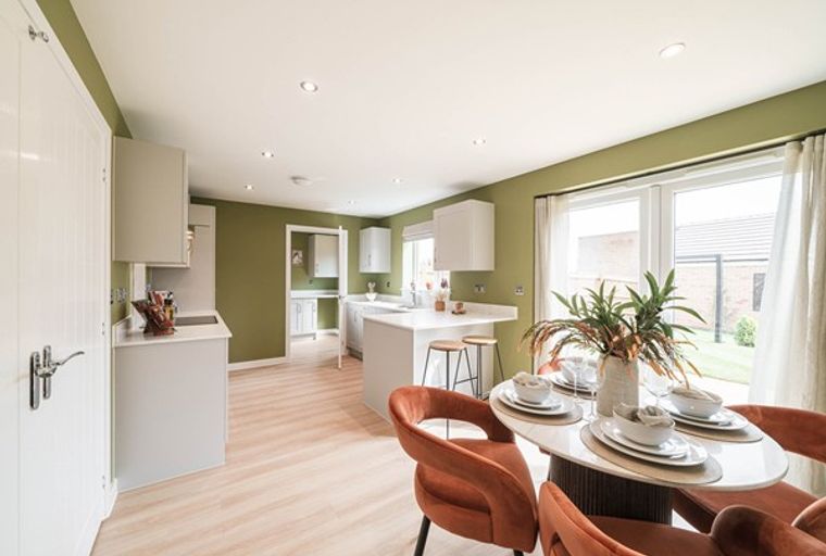 A kitchen and dining area with an island, a dining table, and chairs.