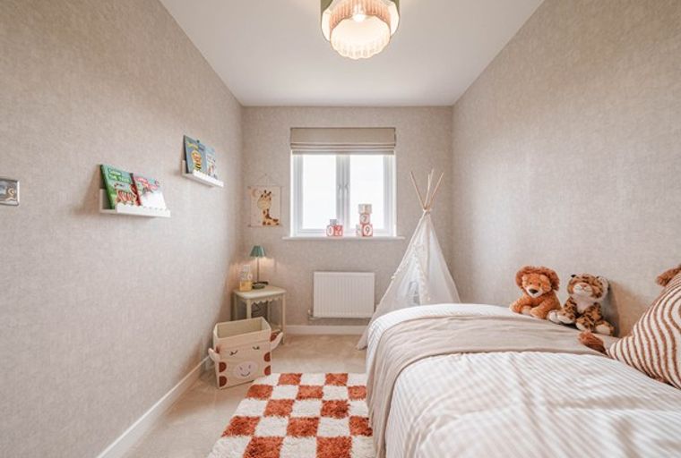 A children's bedroom with a bed, stuffed animals, and a teepee.