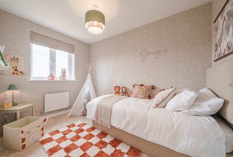 A child's bedroom with a bed, a teepee, and decorative elements.