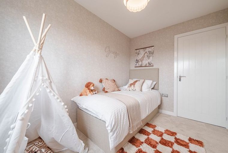 A child's bedroom with a teepee, a bed, and stuffed animals.