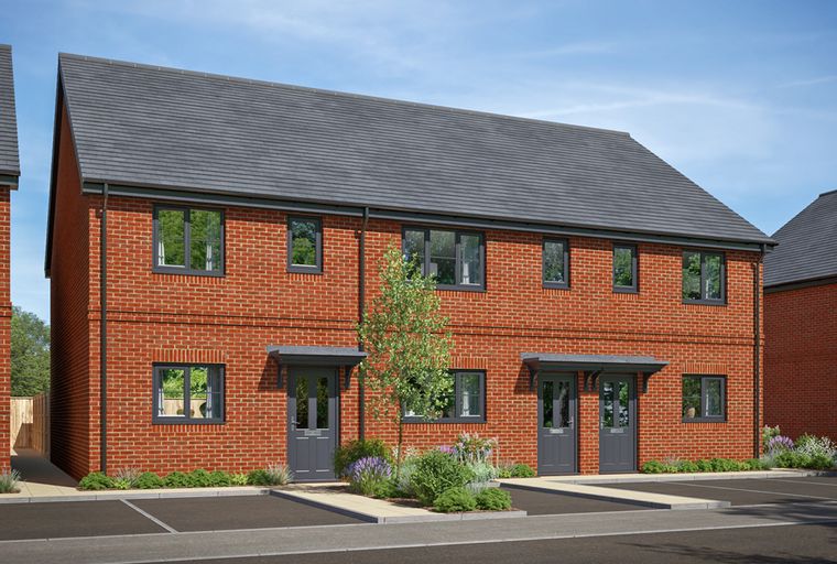 A row of new build red brick houses with grey roofs and doors.