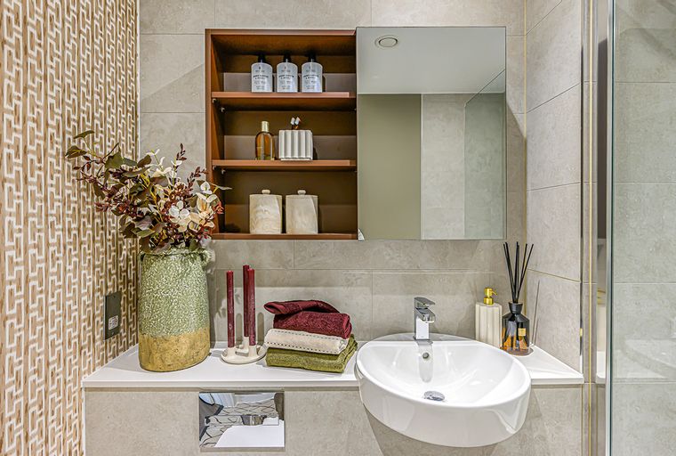 A bathroom vanity with a sink, mirror, and storage shelves.