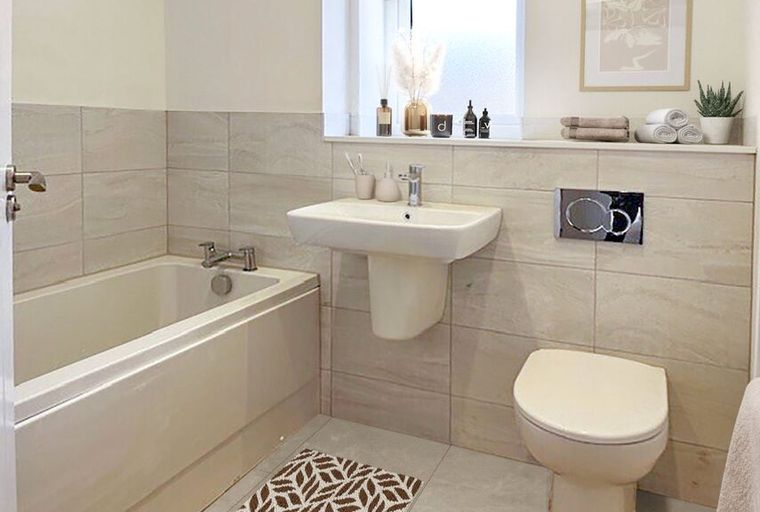 A bathroom with a bathtub, sink, and toilet.
