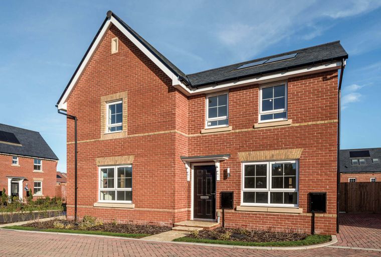 A red brick house with white-framed windows and a dark front door.