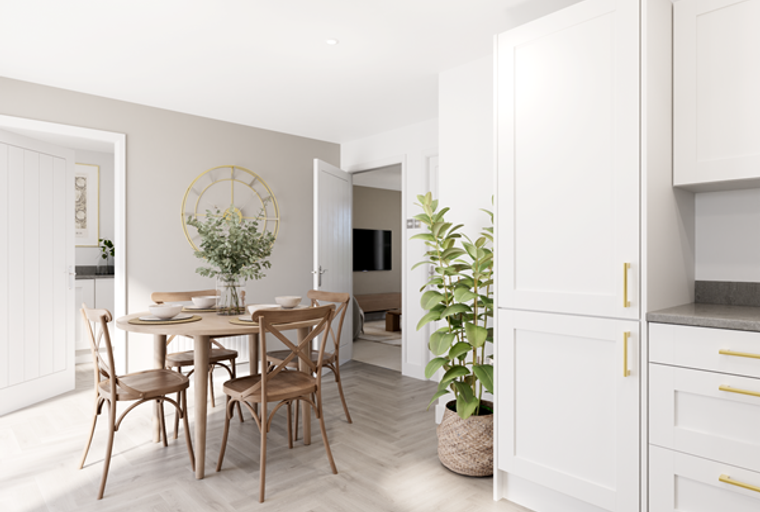 A dining area with a round table and chairs next to a kitchen with white cabinets.