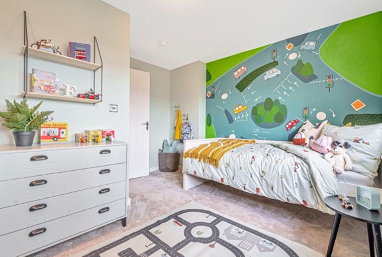 A children's bedroom with a bed, dresser, and a road-themed mural.