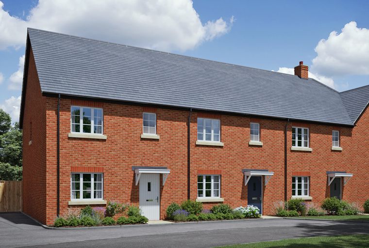 A row of brick townhouses with pitched roofs and windows.