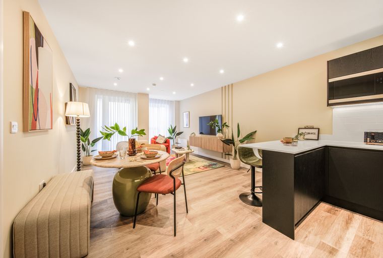 A dining area and kitchen in a modern apartment.