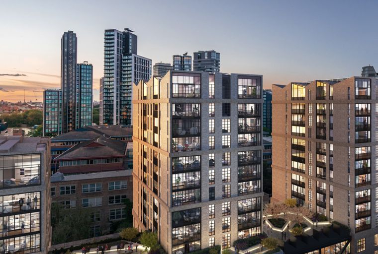 A view of modern apartment buildings at dusk with many windows and balconies.