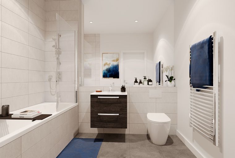 A bathroom with a bathtub, toilet, and vanity.