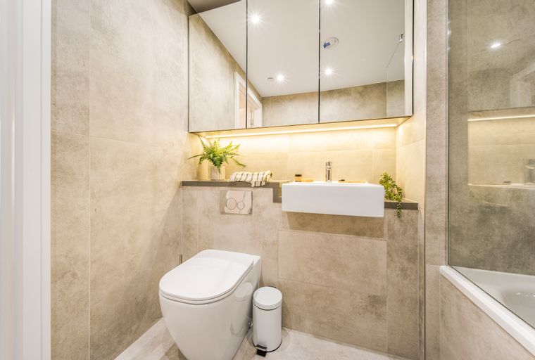 A bathroom with a toilet, sink, and bathtub.
