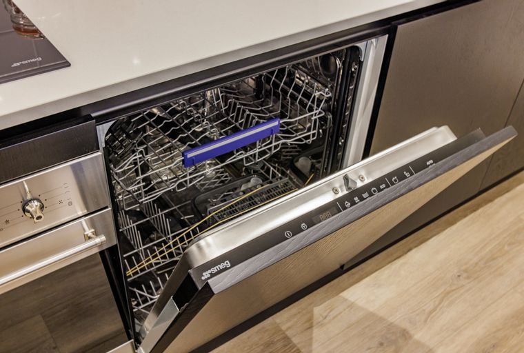 A dishwasher with its door open, showing the interior racks and control panel.