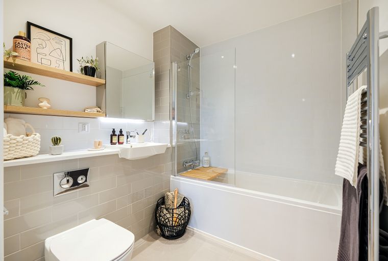 A bathroom with a bathtub, sink, and toilet.