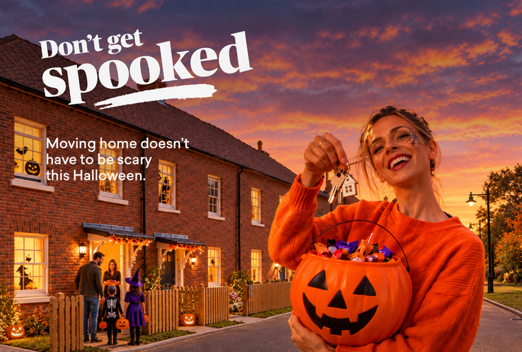 A family is trick-or-treating in front of a row of houses decorated for Halloween.