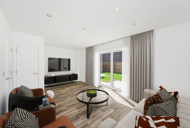 A living room with a sofa, chairs, a coffee table, and a television.