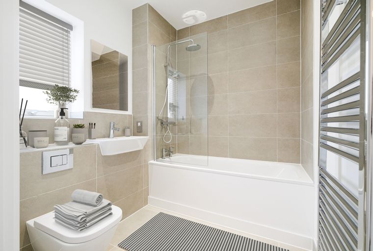 A bathroom with a bathtub, shower, sink, and toilet.