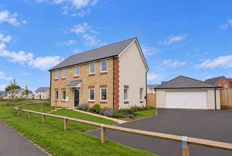 A detached house with a garage and a driveway.