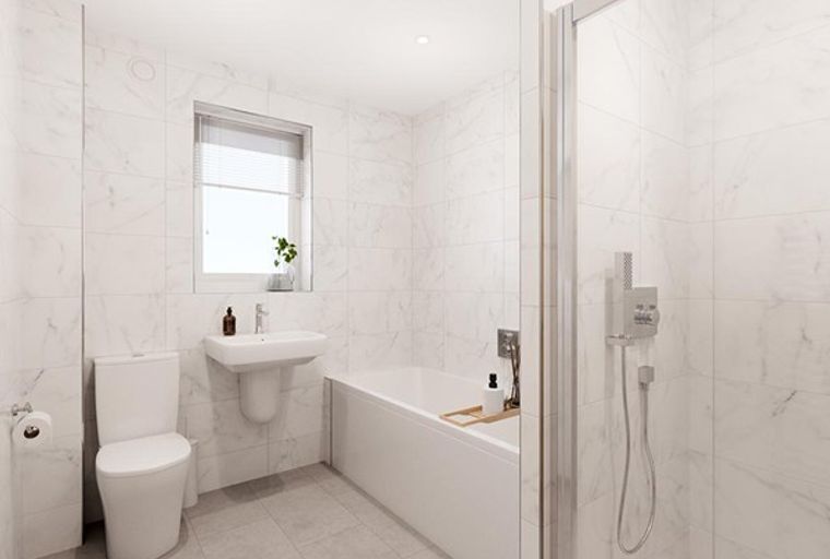 A bathroom with a toilet, sink, bathtub, and shower.