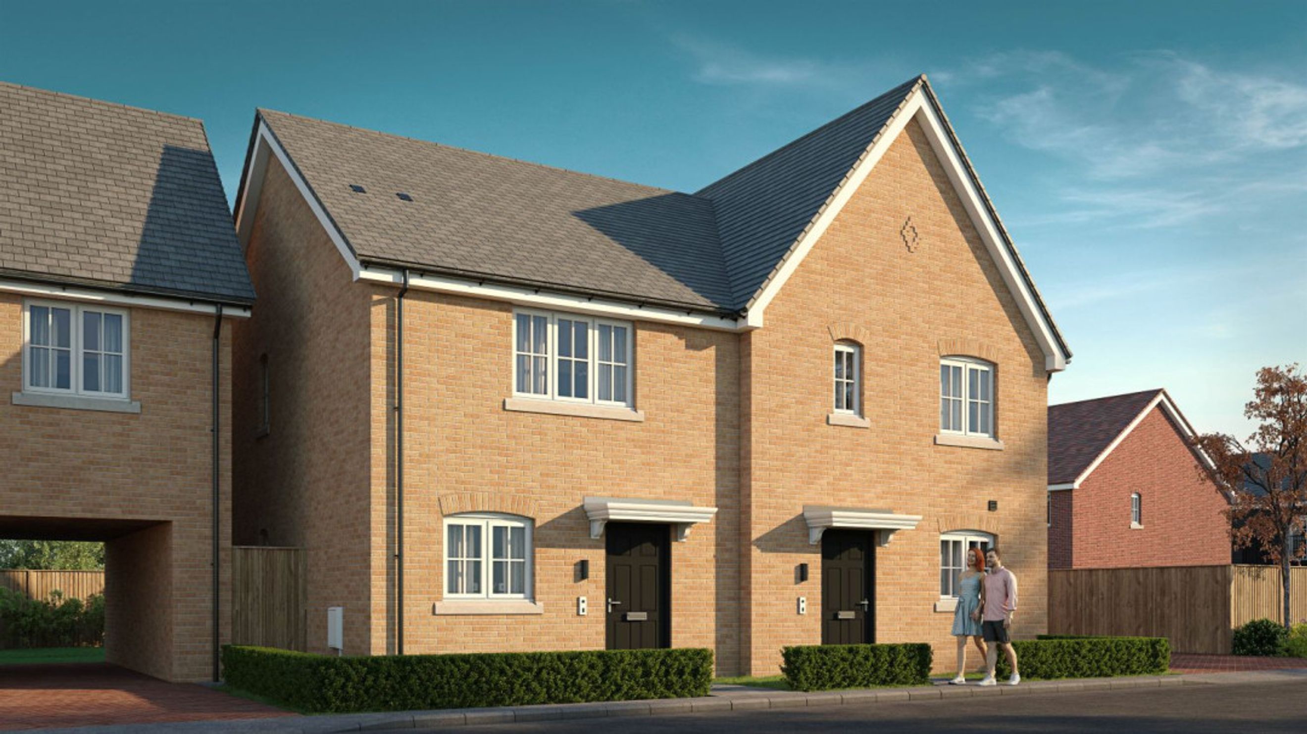 A pair of modern brick houses with dark front doors and manicured hedges.