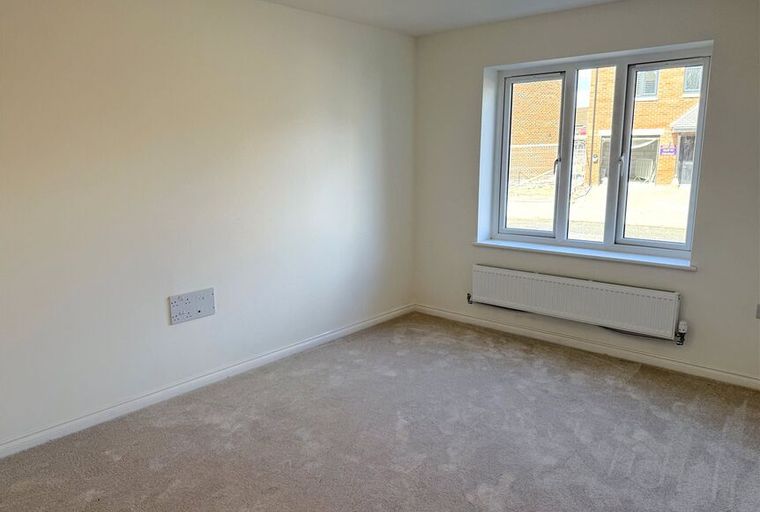 A room with a window and a radiator.