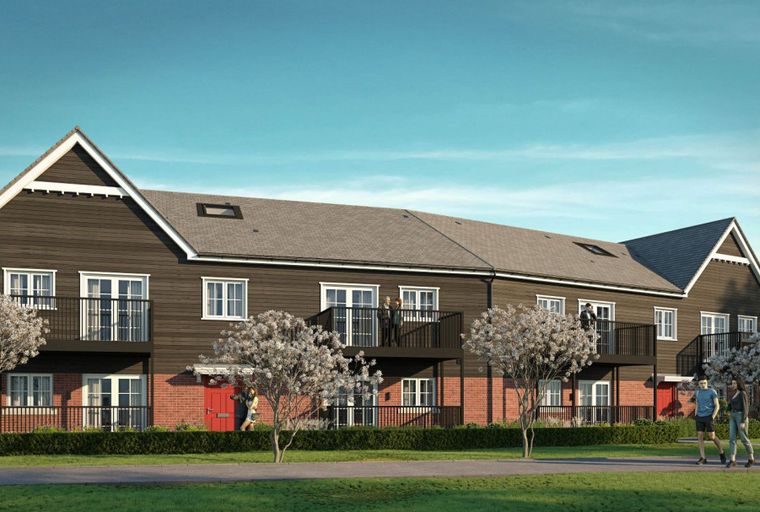A row of modern townhouses with dark wood siding, red brick lower levels, and balconies.