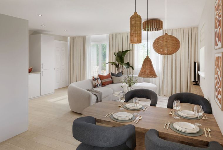 A dining area and living room with a sectional sofa, dining table, and pendant lights.