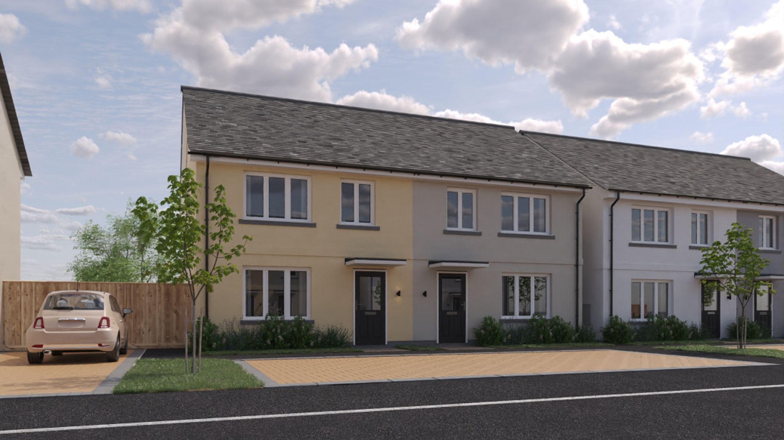A row of modern townhouses with driveways and landscaping.