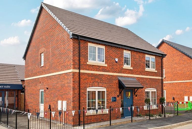A red brick house with white-framed windows and a blue front door.