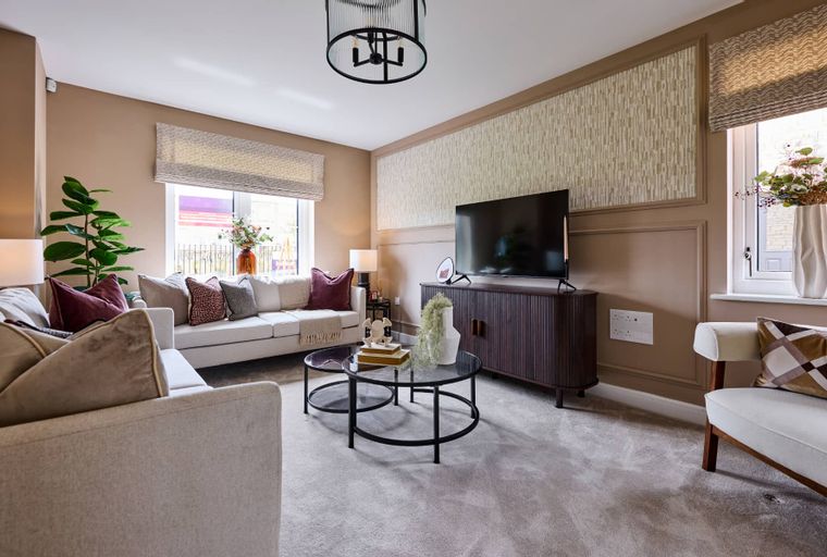 A living room with a sofa, coffee table, and television.