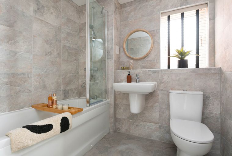 A bathroom with a bathtub, shower, sink, and toilet.