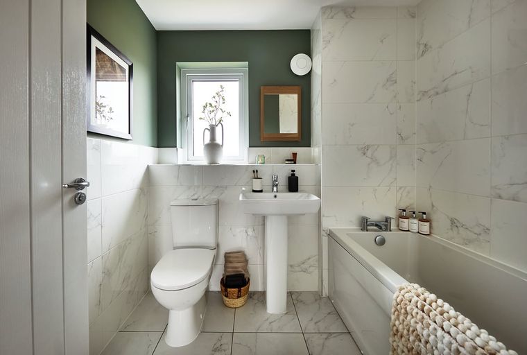 A bathroom with a toilet, sink, and bathtub.