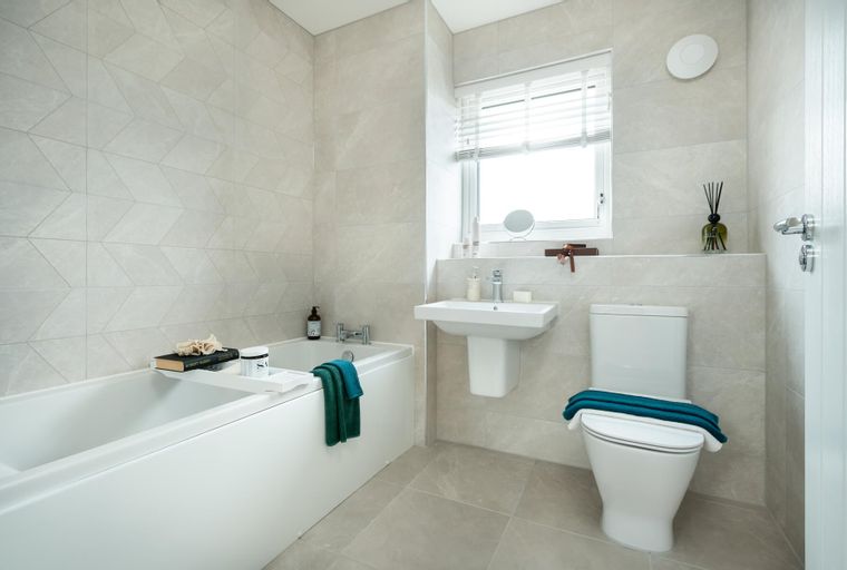 A bathroom with a bathtub, sink, and toilet.