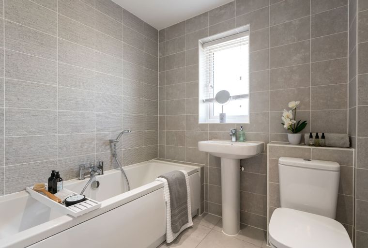 A bathroom with a bathtub, sink, and toilet.
