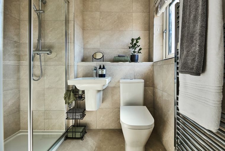 A bathroom with a shower, sink, and toilet.