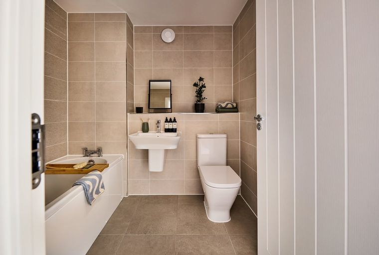 A bathroom with a bathtub, sink, and toilet.