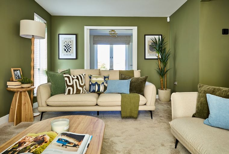 A living room with a sofa, coffee table, and floor lamp.
