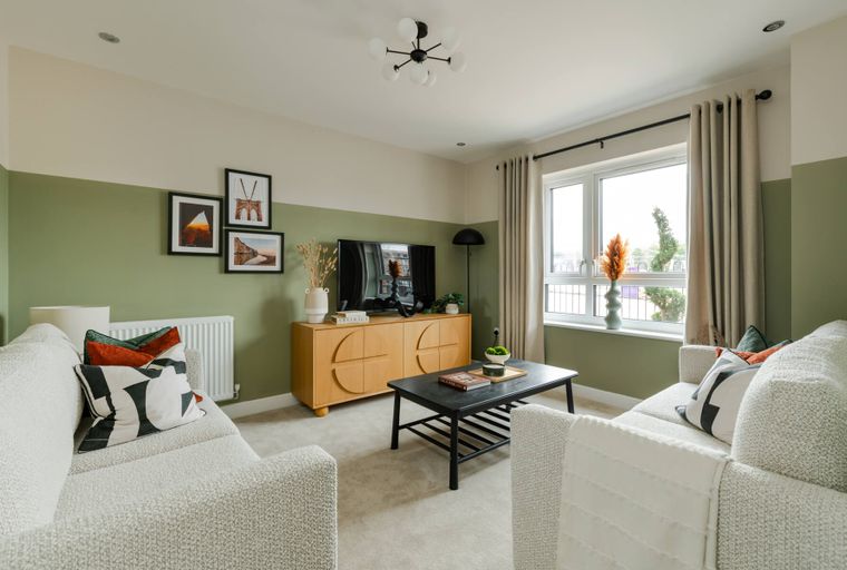 A living room with two sofas, a coffee table, and a media console.