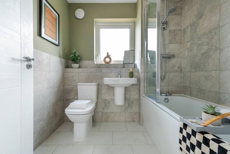 A bathroom with a toilet, sink, and bathtub.