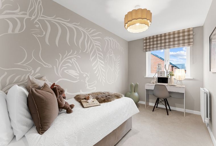 A child's bedroom with a bed, desk, and a rabbit mural on the wall.