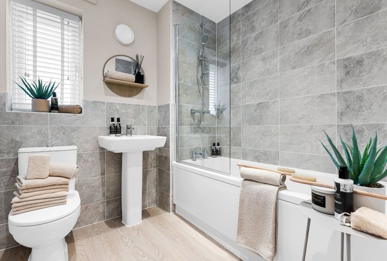 A bathroom with a toilet, sink, and bathtub.