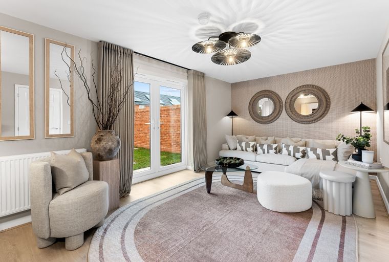 A living room with a sofa, armchair, coffee table, and a large rug.