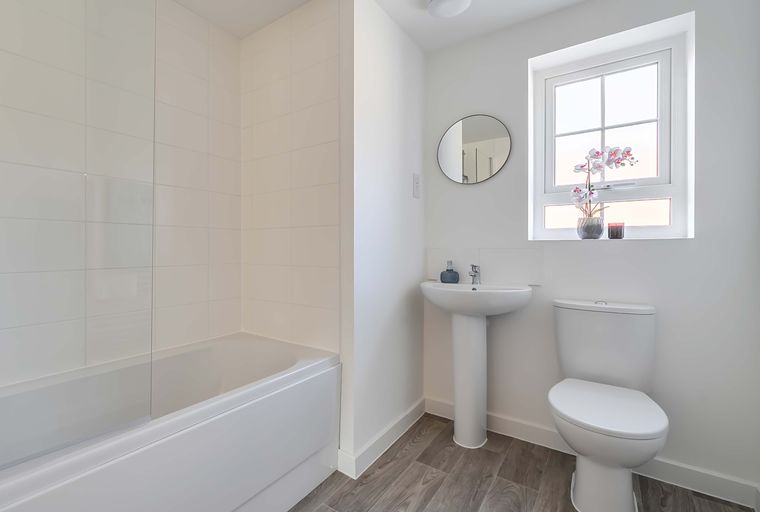 A bathroom with a bathtub, sink, and toilet.