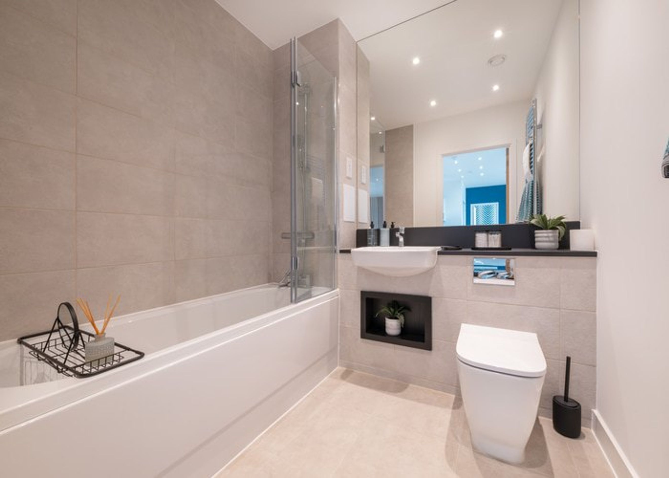 A bathroom with a bathtub, sink, and toilet.
