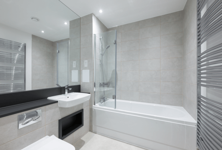 A bathroom with a bathtub, shower, sink, and toilet.