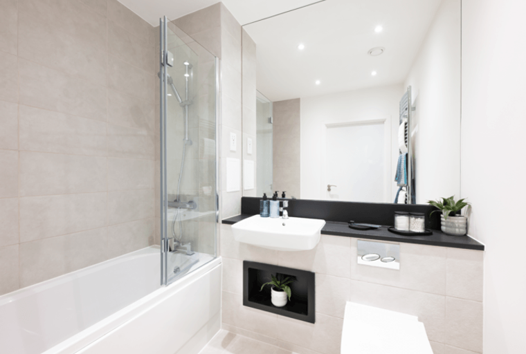 A bathroom with a bathtub, shower, sink, and toilet.