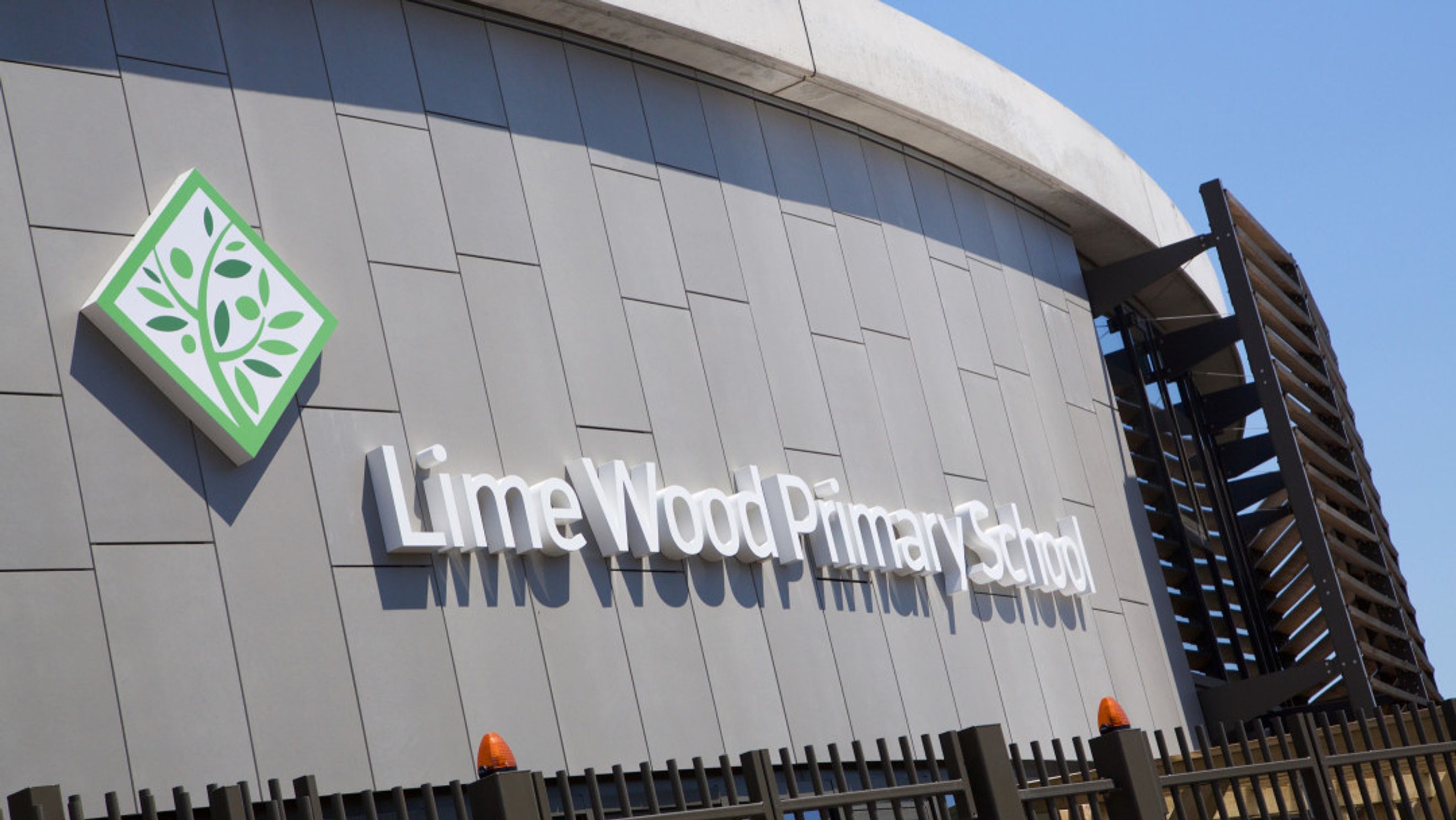 A building with a green logo and white text that reads 'Lime Wood Primary School'.