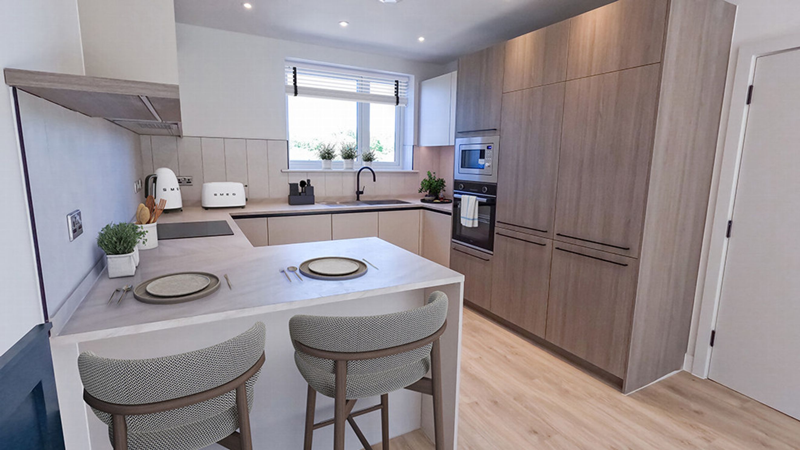 A modern kitchen with light wood cabinets, an island with bar stools, and a window above the sink.